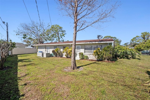 rear view of property featuring a yard