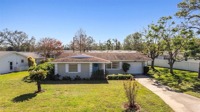 ranch-style house with a garage and a front lawn