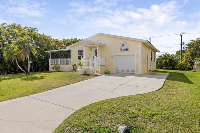 view of front of property with a garage, a front lawn, and a sunroom