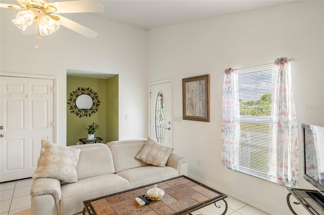 tiled living room with ceiling fan