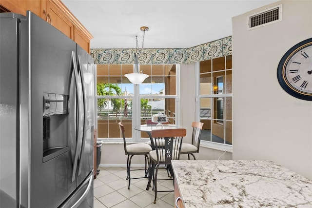 dining space with light tile patterned flooring