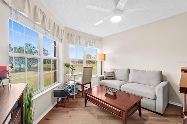 sunroom / solarium featuring ceiling fan