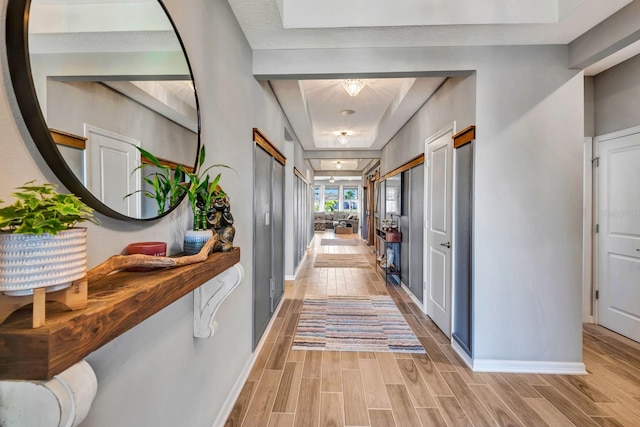 hall with wood finish floors and baseboards