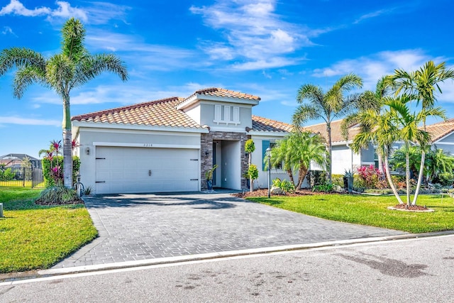 mediterranean / spanish-style home with a front lawn, decorative driveway, an attached garage, and stucco siding