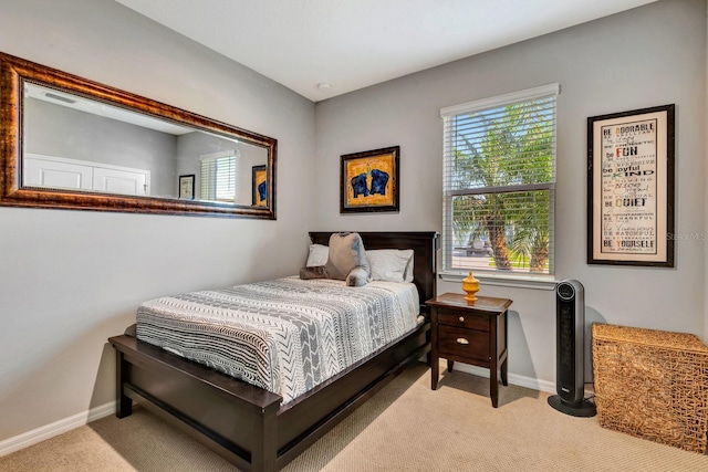 bedroom featuring baseboards and light colored carpet