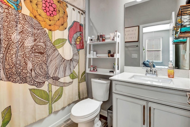 bathroom featuring vanity, toilet, and shower / bath combo with shower curtain