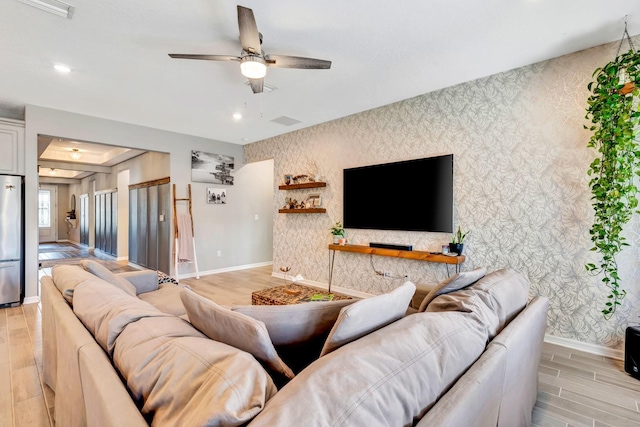 living area featuring baseboards and wallpapered walls