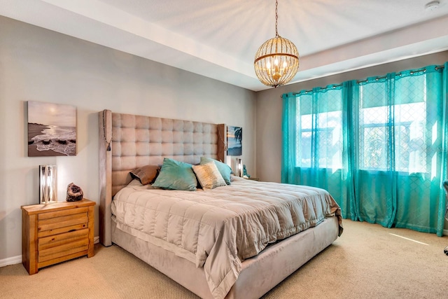 bedroom featuring carpet flooring and a notable chandelier