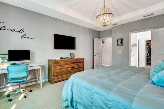 bedroom featuring a chandelier, a walk in closet, visible vents, and light colored carpet