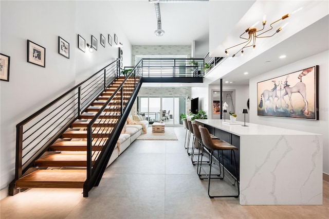 stairs featuring a high ceiling