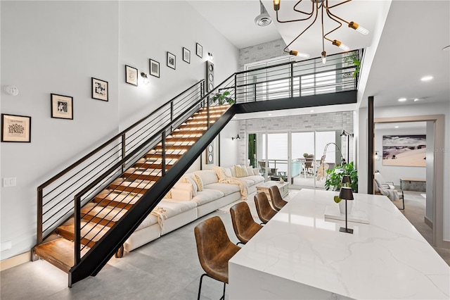 dining room with recessed lighting, visible vents, stairway, a towering ceiling, and an inviting chandelier