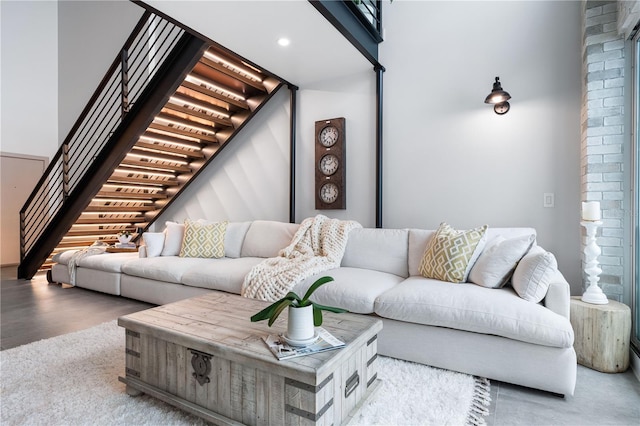 living room featuring light wood finished floors, stairway, and recessed lighting