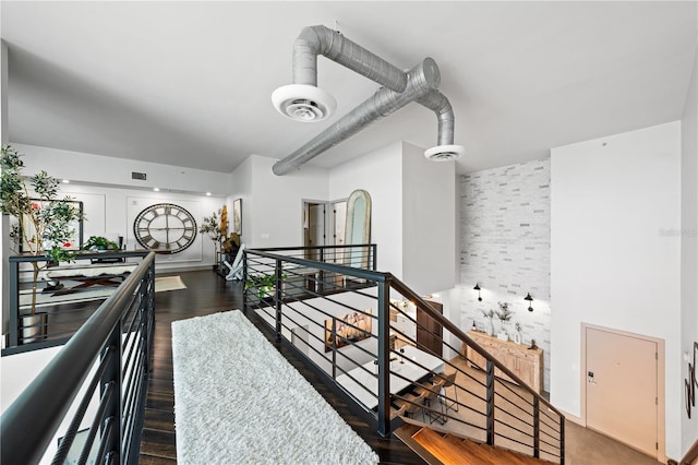 hallway with dark hardwood / wood-style flooring