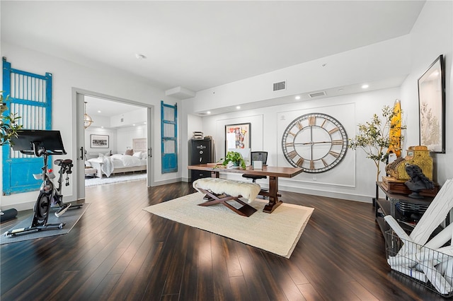 interior space with dark wood-type flooring, visible vents, and baseboards