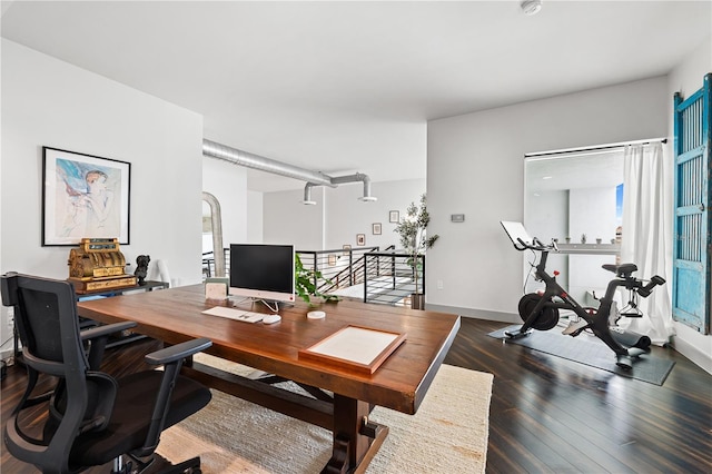 home office with dark wood-type flooring