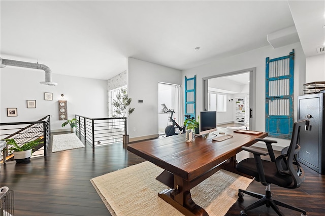 office space featuring a healthy amount of sunlight, dark wood finished floors, and visible vents