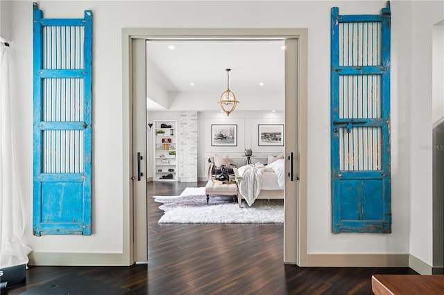 foyer featuring baseboards, dark wood-type flooring, and recessed lighting