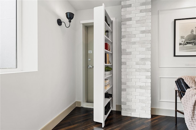 interior space featuring dark wood-type flooring and baseboards