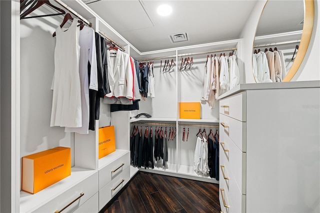 spacious closet with dark wood-type flooring and visible vents