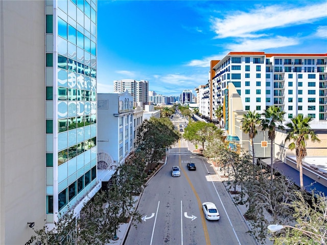 exterior space featuring uncovered parking and a city view