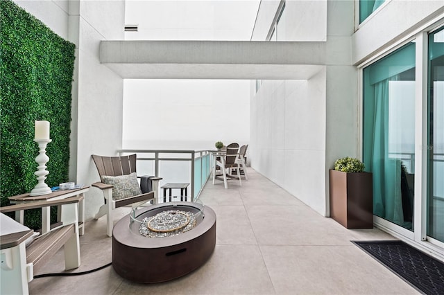 view of patio featuring an outdoor fire pit and visible vents