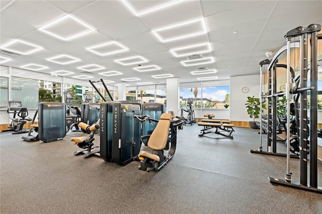 workout area with a drop ceiling and visible vents