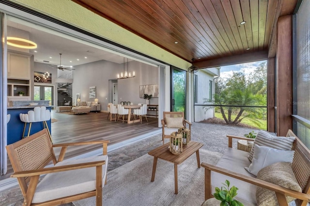 sunroom / solarium with wooden ceiling and ceiling fan