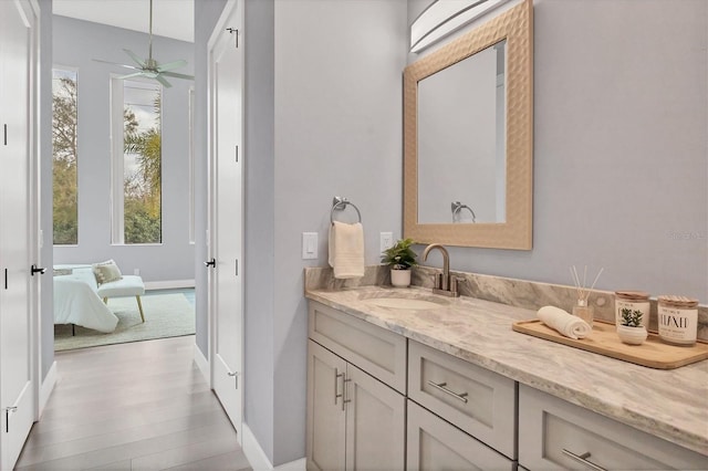 bathroom with vanity, hardwood / wood-style flooring, and ceiling fan