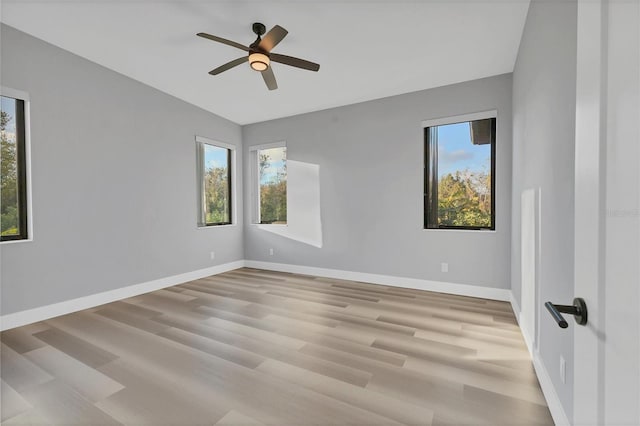 spare room featuring ceiling fan, a healthy amount of sunlight, and light hardwood / wood-style floors