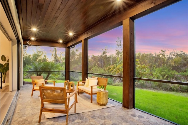 sunroom featuring wood ceiling and plenty of natural light