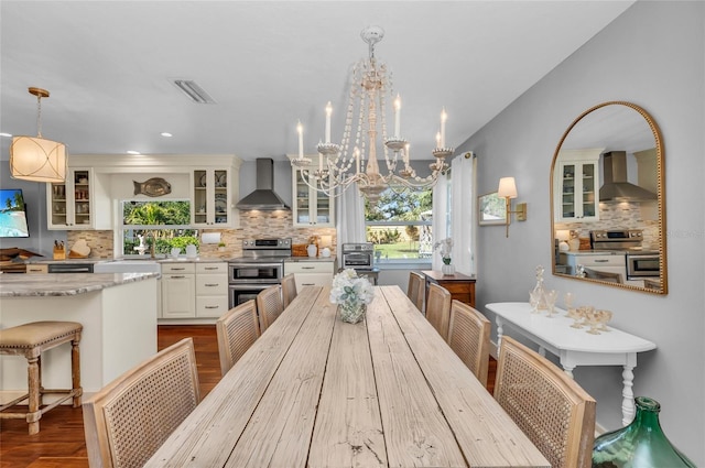7820 Seville Cir, Bradenton, FL 34209 - dining space with dark wood-style flooring, healthy amount of natural light, and a chandelier