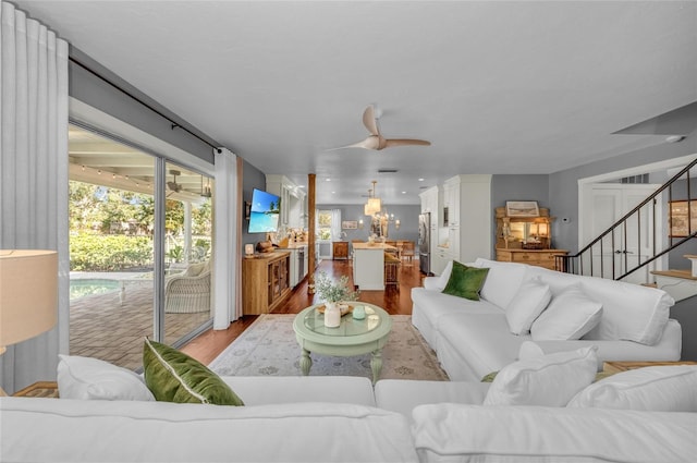 7820 Seville Cir, Bradenton, FL 34209 - living room featuring wood finished floors, stairs, and a chandelier