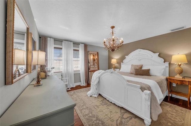 7820 Seville Cir, Bradenton, FL 34209 - bedroom with a chandelier and light wood-type flooring