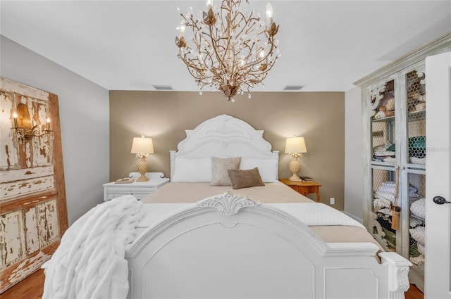 7820 Seville Cir, Bradenton, FL 34209 - bedroom featuring a chandelier and wood finished floors