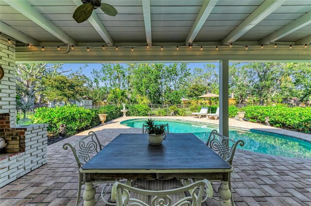 7820 Seville Cir, Bradenton, FL 34209 - fenced backyard featuring a patio area, a ceiling fan, and outdoor dining space
