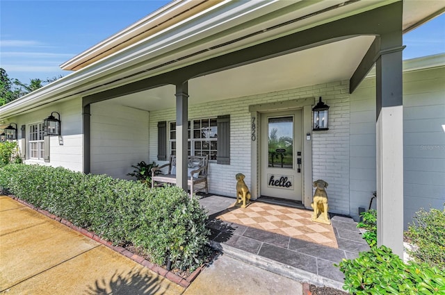 7820 Seville Cir, Bradenton, FL 34209 - doorway to property featuring covered porch and brick siding