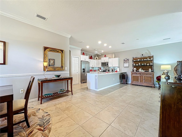 kitchen featuring visible vents, crown molding, light countertops, appliances with stainless steel finishes, and white cabinets