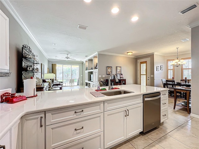 kitchen featuring visible vents, a sink, white cabinetry, crown molding, and dishwasher