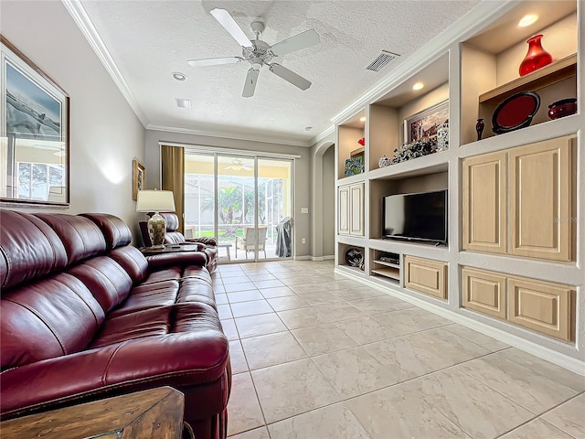 living room with visible vents, crown molding, ceiling fan, built in features, and a textured ceiling