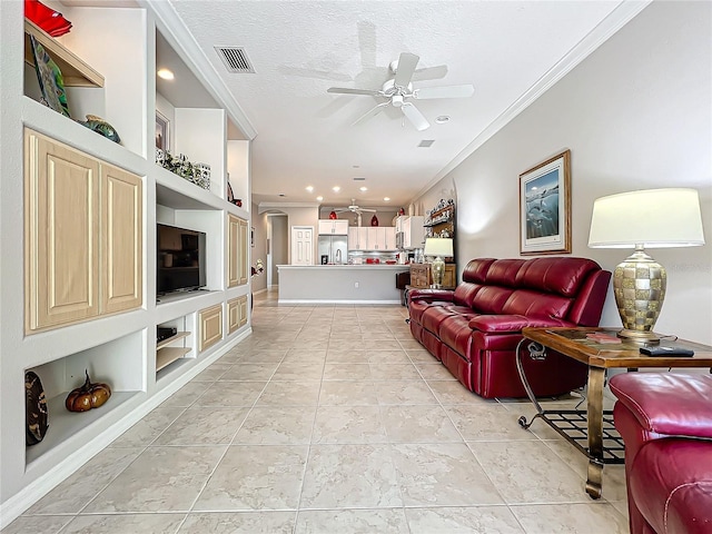 living area with visible vents, a ceiling fan, built in features, a textured ceiling, and crown molding