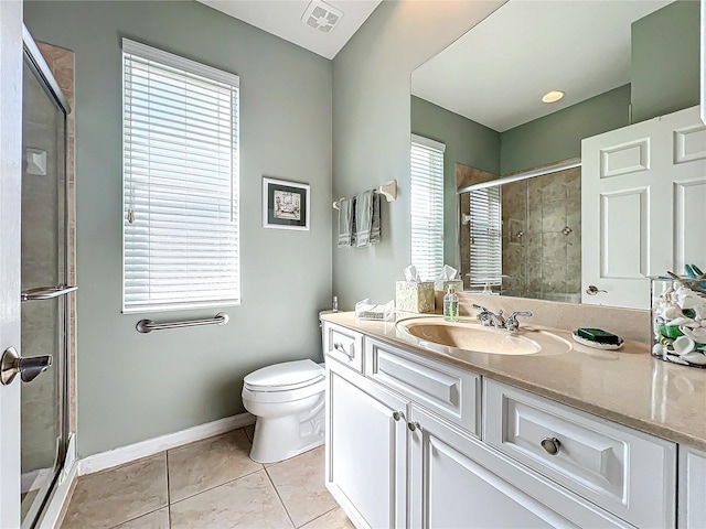 bathroom featuring vanity, baseboards, visible vents, a stall shower, and tile patterned floors