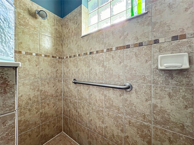 bathroom with a tile shower