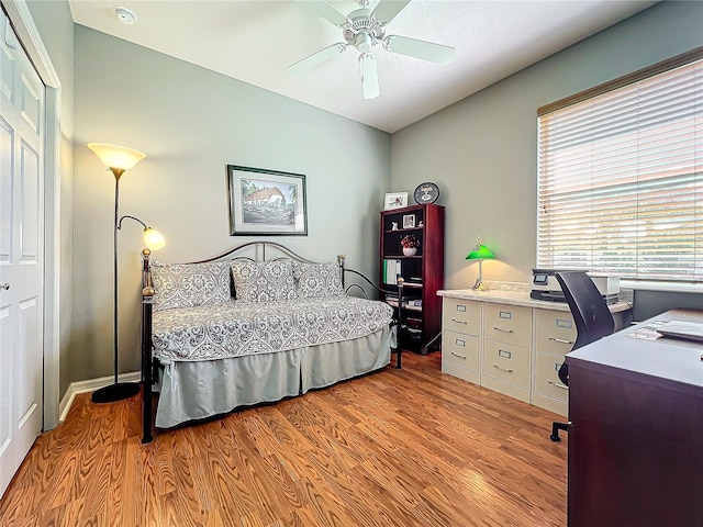 bedroom with light wood-style floors and ceiling fan