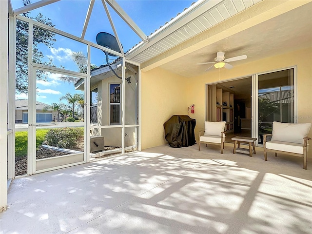 unfurnished sunroom featuring ceiling fan