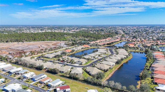 drone / aerial view with a residential view and a water view