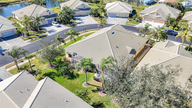 drone / aerial view featuring a residential view and a water view