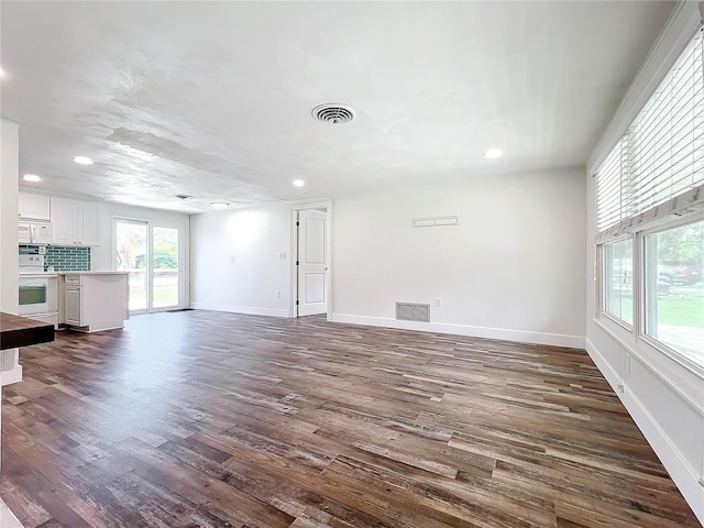 unfurnished living room featuring dark wood-type flooring