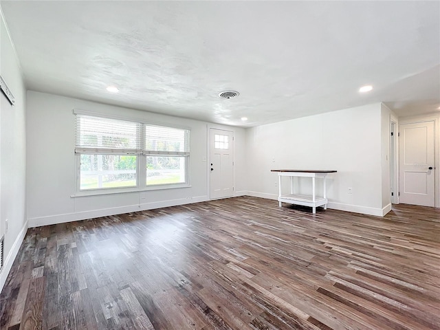 unfurnished living room featuring dark hardwood / wood-style flooring