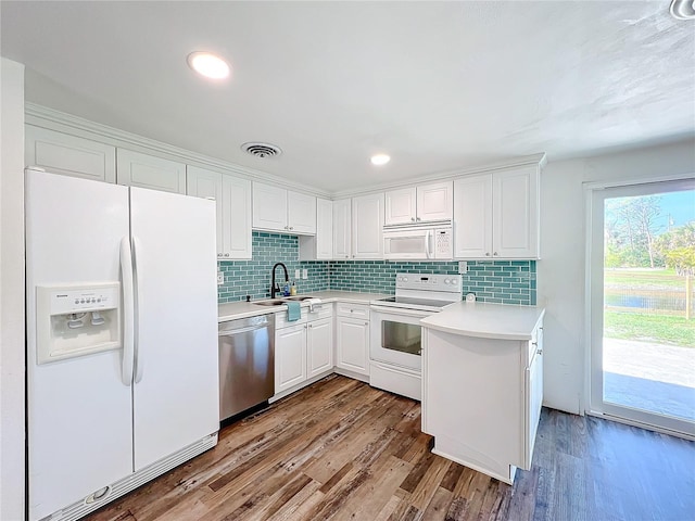 kitchen featuring sink, white cabinets, white appliances, and light wood-type flooring