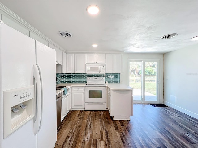 kitchen featuring white cabinetry, dark hardwood / wood-style flooring, decorative backsplash, kitchen peninsula, and white appliances